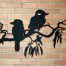 Metal wall art design of 2 Australian Kookaburra birds perched on a branch.