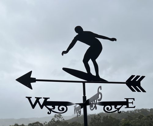 Weathervane featuring a surfer balancing on his board.